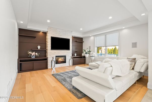 Fireplace, Interior, Living room, Recessed Lighting, Stone Walls, Wood Texture Flooring