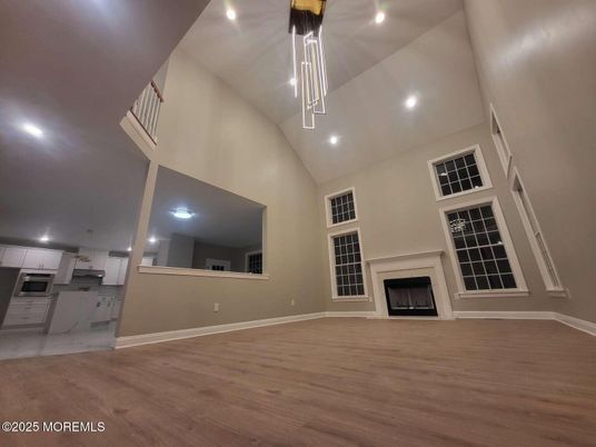 Empty room, Fireplace, Interior, Kitchen, Pendant Lights, Recessed Lighting, Wood Texture Flooring