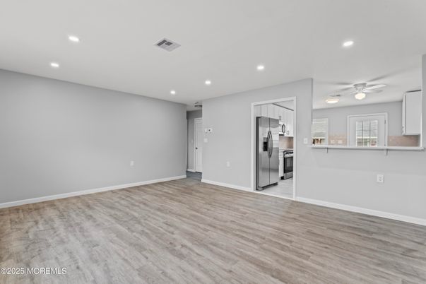 Empty room, Interior, Kitchen, Recessed Lighting, Stainless Steel Appliances, Wood Texture Flooring