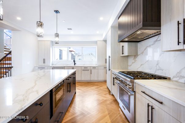 Interior, Kitchen, Marble Walls, Pendant Lights, Recessed Lighting, Stainless Steel Appliances, Wood Texture Flooring