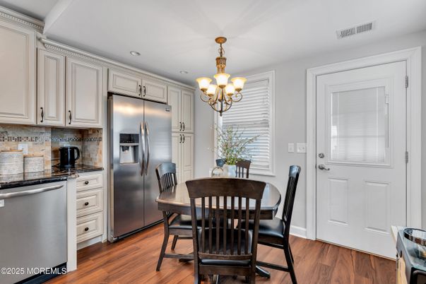 Chandelier, Dining room, Interior, Kitchen, Recessed Lighting, Stainless Steel Appliances, Wood Texture Flooring