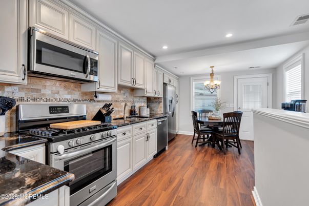 Chandelier, Dining room, Interior, Kitchen, Recessed Lighting, Stainless Steel Appliances, Wood Texture Flooring