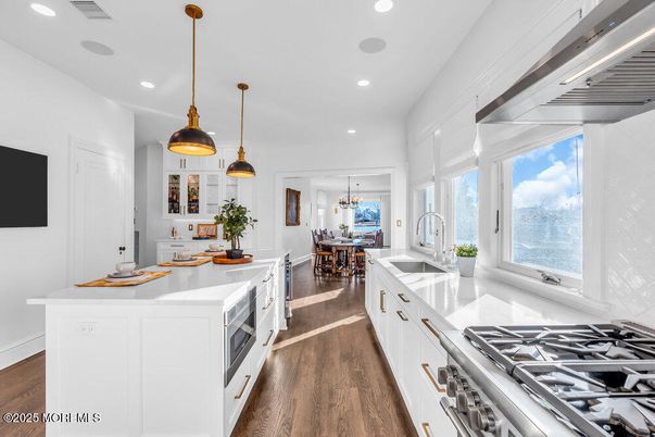 Chandelier, Dining room, Interior, Kitchen, Pendant Lights, Recessed Lighting, Stainless Steel Appliances, Wood Texture Flooring