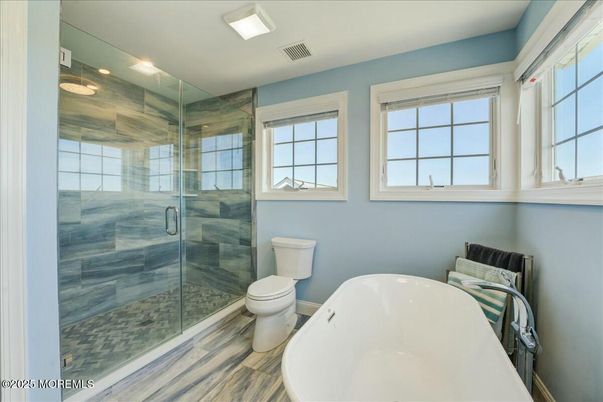 Bathroom, Free Standing Baths, Glass Shower, Interior, Recessed Lighting, Wood Texture Flooring