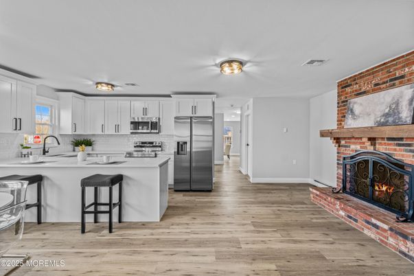 Fireplace, Interior, Kitchen, Stainless Steel Appliances, Stone Walls, Wood Texture Flooring
