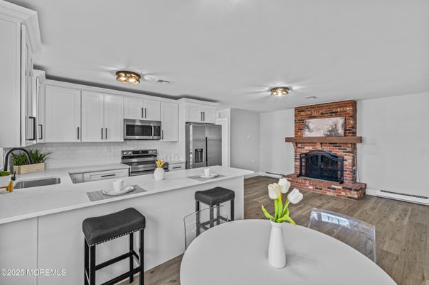 Fireplace, Interior, Kitchen, Stainless Steel Appliances, Stone Walls, Wood Texture Flooring