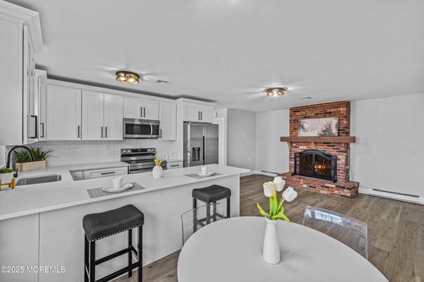 Fireplace, Interior, Kitchen, Stainless Steel Appliances, Stone Walls, Wood Texture Flooring