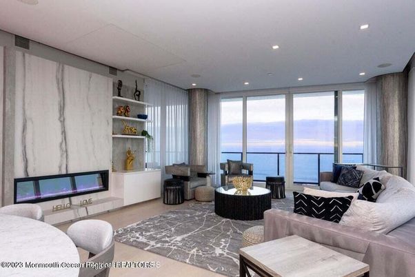 Fireplace, Interior, Living room, Marble Walls, Recessed Lighting, Water, Wood Texture Flooring