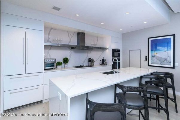 Interior, Kitchen, Marble Walls, Recessed Lighting, Stainless Steel Appliances, Wood Texture Flooring