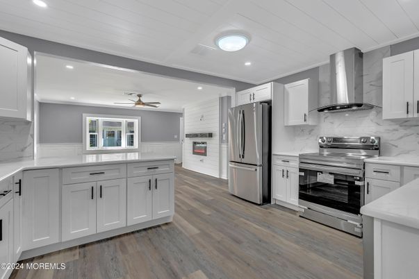 Interior, Kitchen, Marble Walls, Recessed Lighting, Stainless Steel Appliances, Wood Texture Flooring