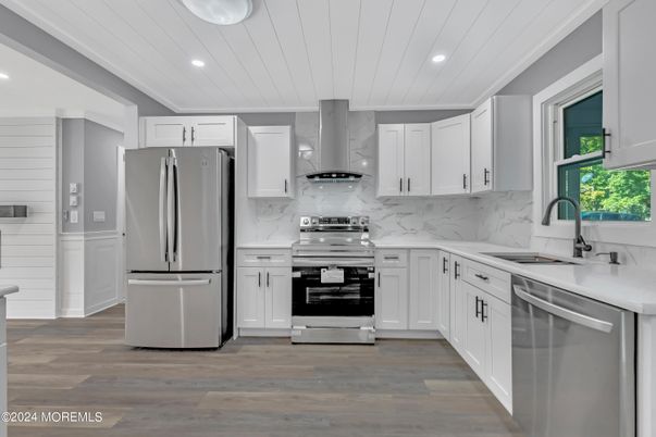 Interior, Kitchen, Marble Walls, Recessed Lighting, Stainless Steel Appliances, Wood Texture Flooring