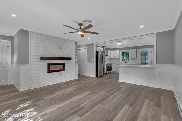 Fireplace, Interior, Kitchen, Recessed Lighting, Stainless Steel Appliances, Wood Texture Flooring