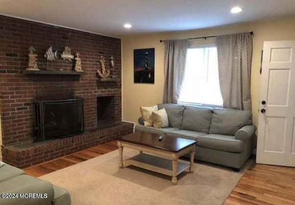 Fireplace, Interior, Living room, Recessed Lighting, Stone Walls, Wood Texture Flooring