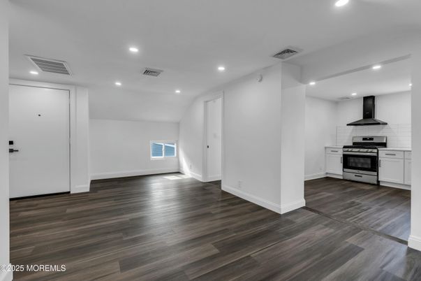 Empty room, Interior, Kitchen, Recessed Lighting, Stainless Steel Appliances, Wood Texture Flooring