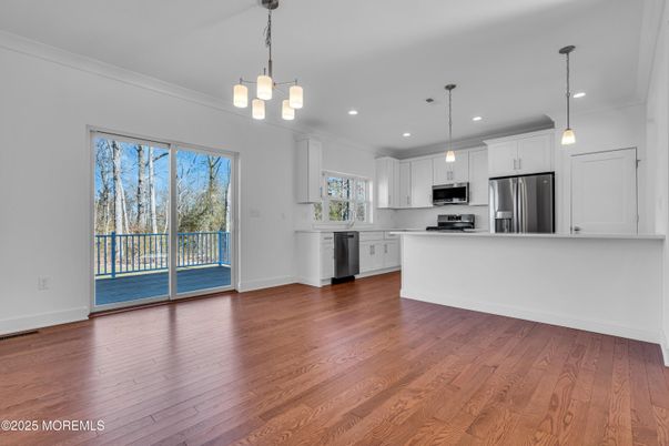 Empty room, Interior, Kitchen, Pendant Lights, Recessed Lighting, Stainless Steel Appliances, Wood Texture Flooring