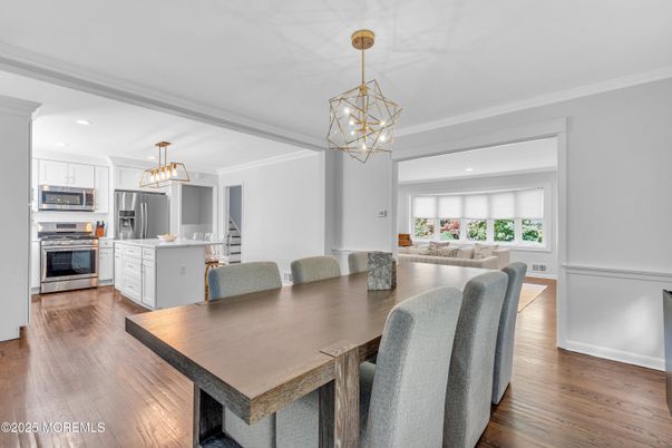 Chandelier, Dining room, Interior, Kitchen, Living room, Pendant Lights, Recessed Lighting, Stainless Steel Appliances, Wood Texture Flooring