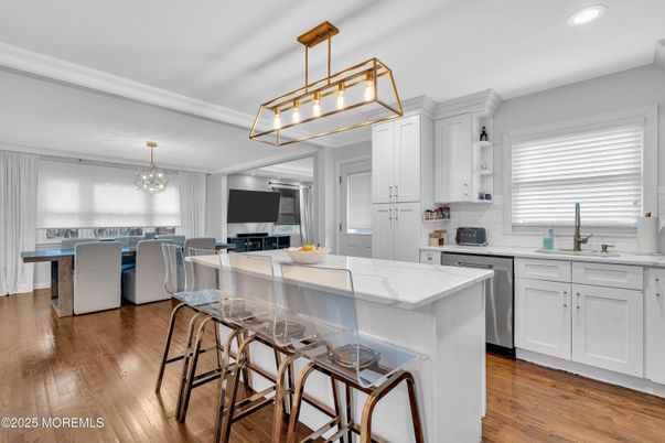 Chandelier, Dining room, Interior, Kitchen, Pendant Lights, Recessed Lighting, Stainless Steel Appliances, Wood Texture Flooring