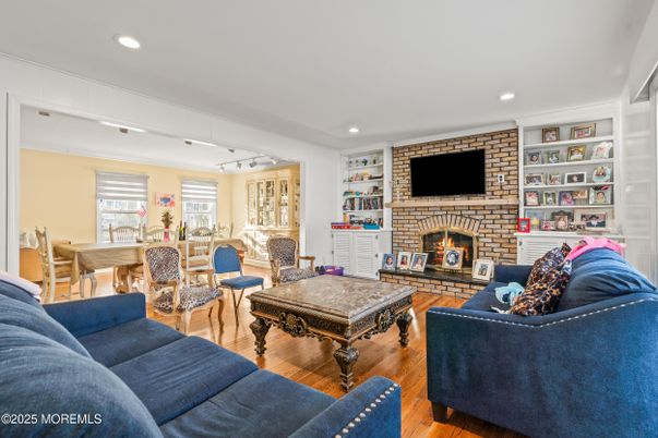 Dining room, Fireplace, Interior, Living room, Recessed Lighting, Stone Walls, Wood Texture Flooring
