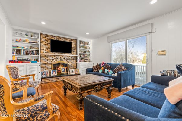 Fireplace, Interior, Living room, Recessed Lighting, Stone Walls, Wood Texture Flooring