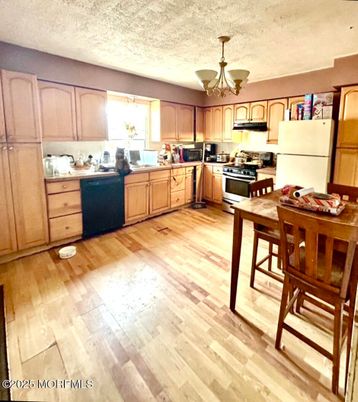 Chandelier, Dining room, Interior, Kitchen, Stainless Steel Appliances, Wood Texture Flooring
