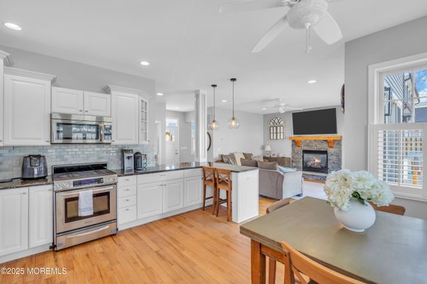 Dining room, Fireplace, Interior, Kitchen, Living room, Pendant Lights, Recessed Lighting, Stainless Steel Appliances, Wood Texture Flooring