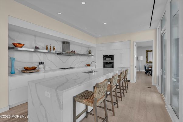 Interior, Kitchen, Marble Walls, Recessed Lighting, Stainless Steel Appliances, Wood Texture Flooring