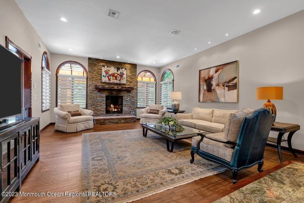 Fireplace, Interior, Living room, Recessed Lighting, Stone Walls, Wood Texture Flooring