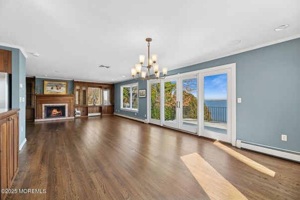 Chandelier, Empty room, Fireplace, Interior, Recessed Lighting, Water, Wood Texture Flooring