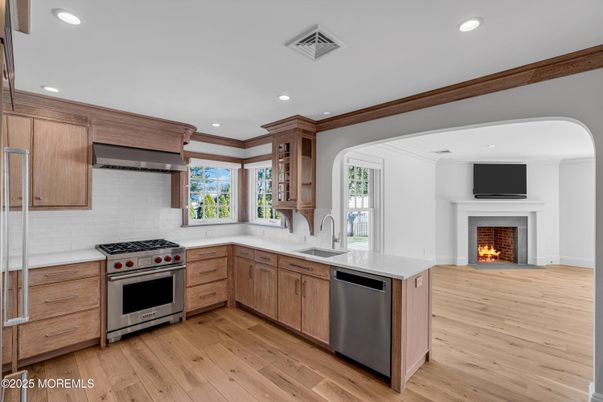 Fireplace, Interior, Kitchen, Recessed Lighting, Stainless Steel Appliances, Wood Texture Flooring