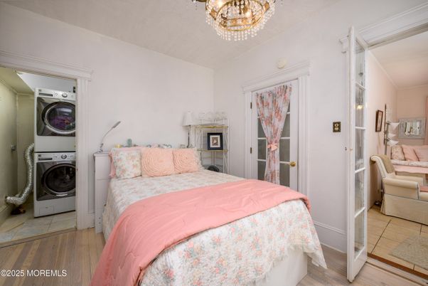 Bedroom, Chandelier, Interior, Utility Closets, Washer, Wood Texture Flooring