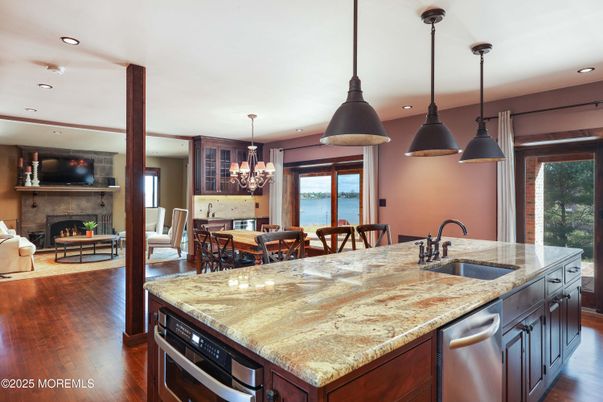 Chandelier, Dining room, Fireplace, Interior, Kitchen, Living room, Pendant Lights, Recessed Lighting, Water, Wood Texture Flooring