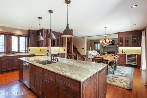 Chandelier, Dining room, Fireplace, Interior, Kitchen, Living room, Pendant Lights, Recessed Lighting, Stainless Steel Appliances, Wood Texture Flooring