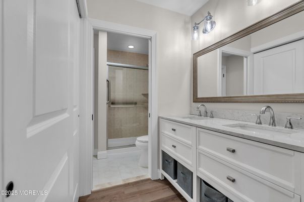 Bathroom, Dual Sink Vanities, Glass Shower, Interior, Recessed Lighting, Wood Texture Flooring