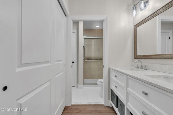 Bathroom, Dual Sink Vanities, Glass Shower, Interior, Recessed Lighting, Wood Texture Flooring