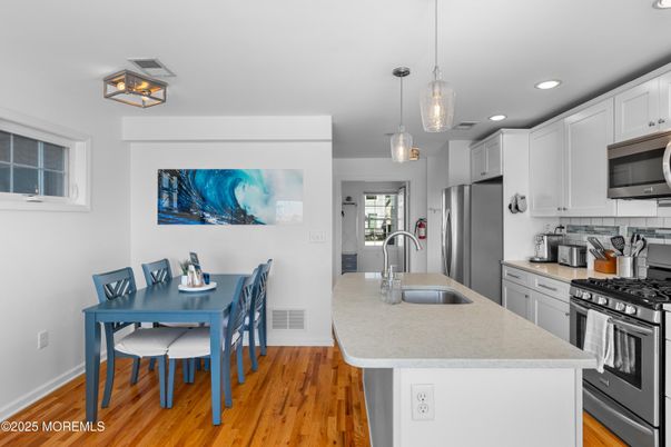 Dining room, Interior, Kitchen, Pendant Lights, Recessed Lighting, Stainless Steel Appliances, Wood Texture Flooring