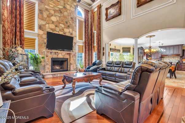 Chandelier, Dining room, Fireplace, Interior, Living room, Pendant Lights, Stone Walls, Wood Texture Flooring