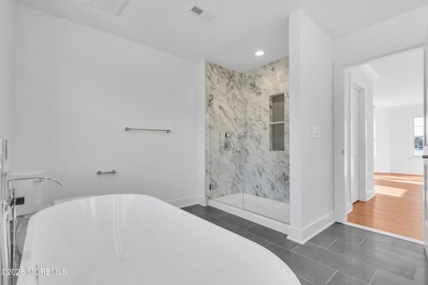 Bathroom, Free Standing Baths, Glass Shower, Interior, Marble Walls, Recessed Lighting, Wood Texture Flooring