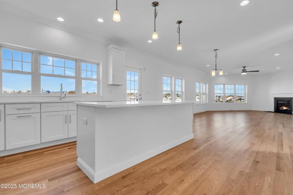 Empty room, Fireplace, Interior, Kitchen, Pendant Lights, Recessed Lighting, Wood Texture Flooring