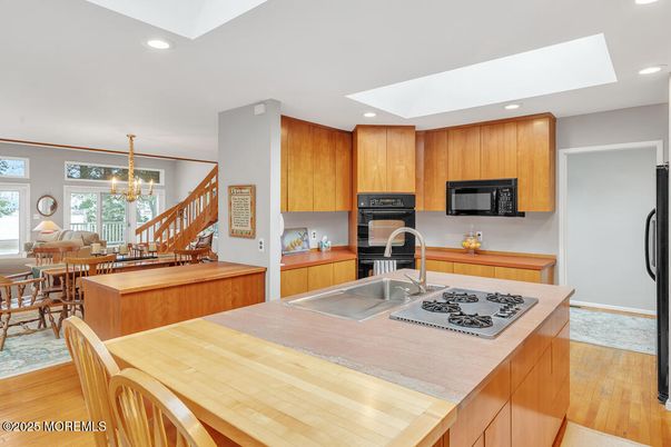 Chandelier, Dining room, Interior, Kitchen, Recessed Lighting, Stainless Steel Appliances, Wood Texture Flooring