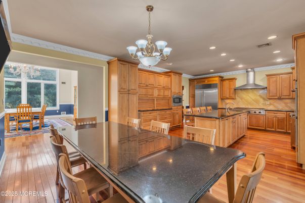 Chandelier, Dining room, Interior, Kitchen, Recessed Lighting, Stainless Steel Appliances, Wood Texture Flooring
