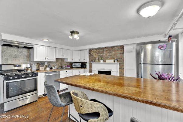 Fireplace, Interior, Kitchen, Stainless Steel Appliances, Stone Walls, Wood Texture Flooring