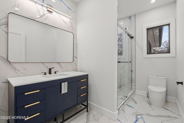 Bathroom, Dual Sink Vanities, Glass Shower, Interior, Marble, Marble Walls, Recessed Lighting