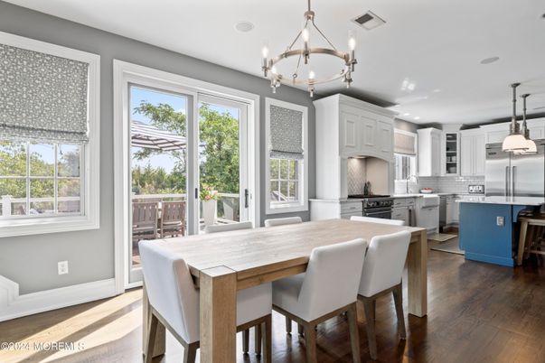 Chandelier, Dining room, Interior, Kitchen, Pendant Lights, Recessed Lighting, Stainless Steel Appliances, Wood Texture Flooring
