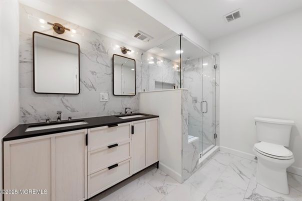 Bathroom, Dual Sink Vanities, Glass Shower, Interior, Marble, Marble Walls, Recessed Lighting