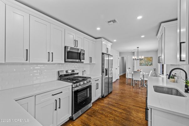 Chandelier, Dining room, Interior, Kitchen, Recessed Lighting, Stainless Steel Appliances, Wood Texture Flooring