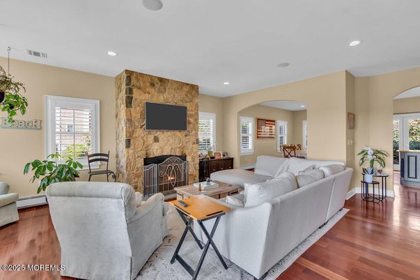 Fireplace, Interior, Living room, Recessed Lighting, Stone Walls, Wood Texture Flooring