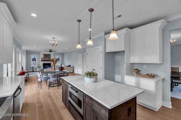 Chandelier, Dining room, Fireplace, Interior, Kitchen, Living room, Pendant Lights, Recessed Lighting, Wood Texture Flooring