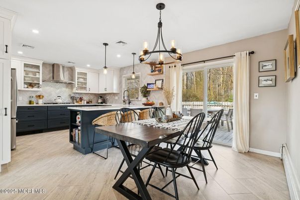 Chandelier, Dining room, Interior, Kitchen, Pendant Lights, Recessed Lighting, Stainless Steel Appliances, Wood Texture Flooring