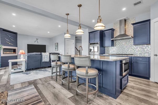 Fireplace, Interior, Kitchen, Living room, Pendant Lights, Recessed Lighting, Stainless Steel Appliances, Wood Texture Flooring