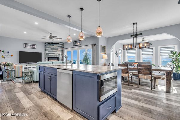 Dining room, Fireplace, Interior, Kitchen, Pendant Lights, Recessed Lighting, Water, Wood Texture Flooring